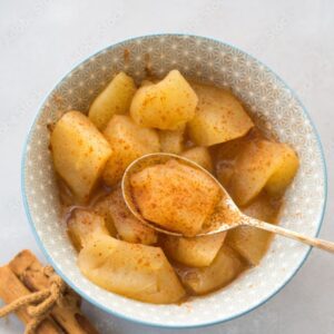 Bowl of cooked apples with cinnamon