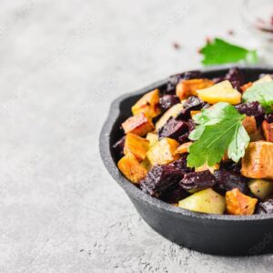 Black bowl with sweet potatoes and vegetables