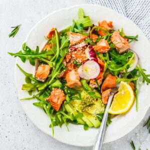 Bowl of salad topped with radishes and avocado
