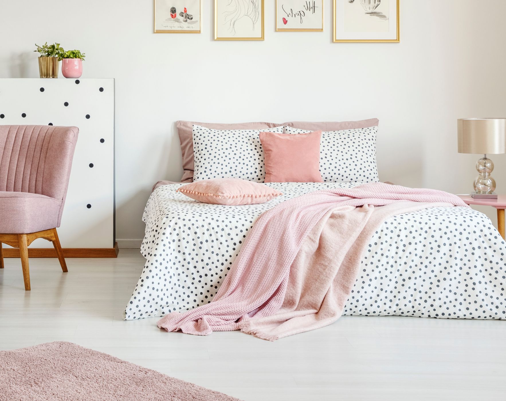 Calm, cozy bedroom with soft pink bedding and pillows representing a peaceful sleep environment for improving sleep with MS.