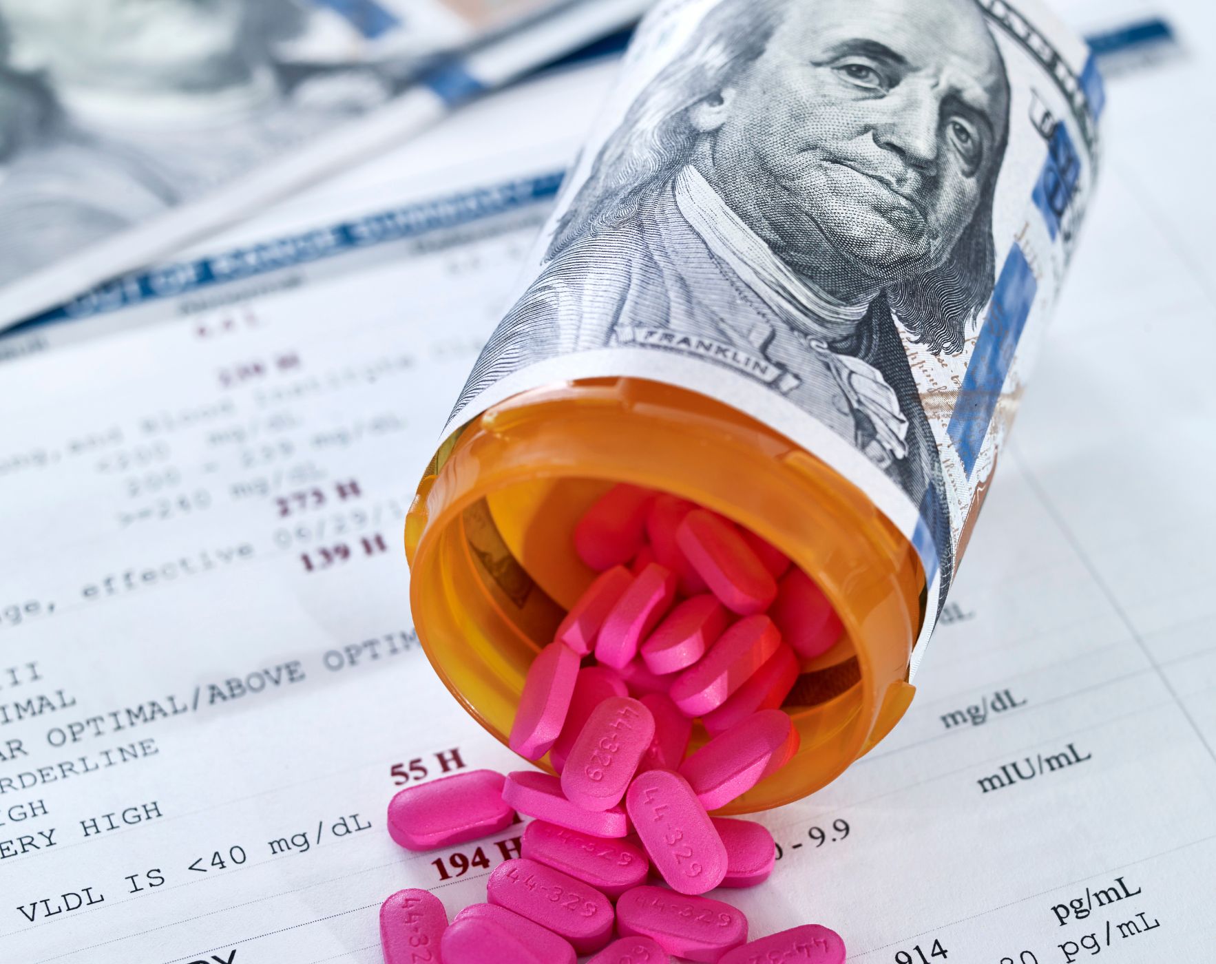 A pile of money and medical bills, representing the financial challenges of living with Multiple Sclerosis and tips for managing healthcare costs.