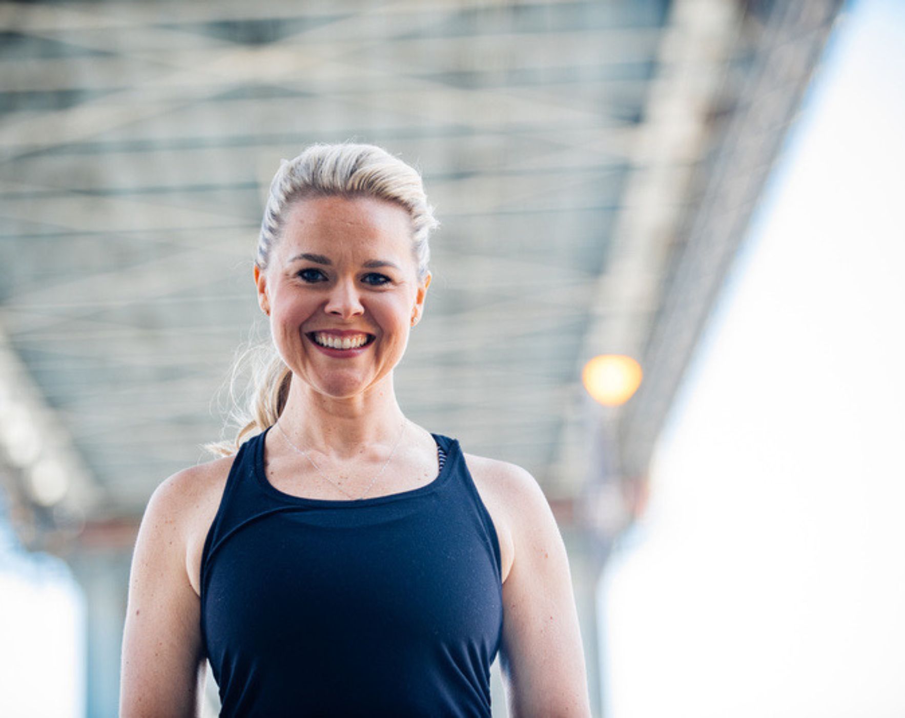 An individual standing strong with arms outstretched towards a sunrise, embodying finding personal strength and hope through an anthem for healing with Multiple Sclerosis.