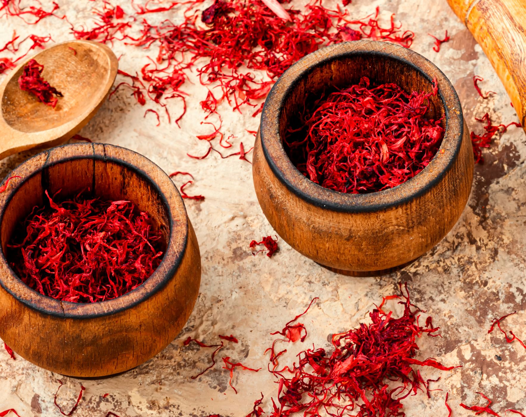 Image showing saffron threads alongside a person performing corrective exercises, exploring if these can help Multiple Sclerosis symptoms like fatigue and clinical disability.