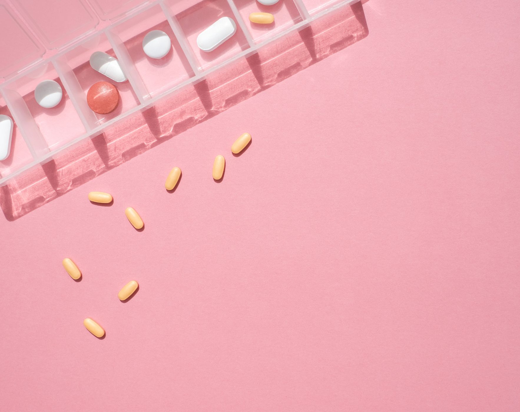 A person looking at multiple medication bottles, representing the challenge of deciding on the best Multiple Sclerosis treatment plan and discussing options with doctors.
