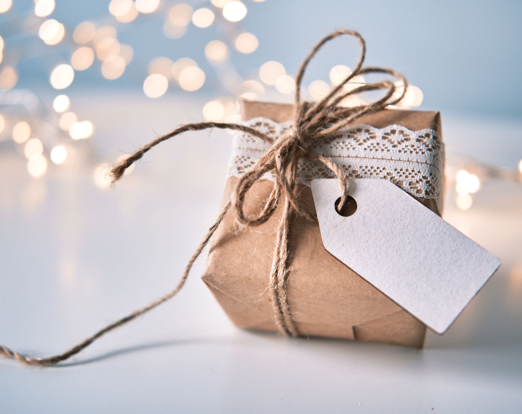 Hands exchanging a thoughtful, modest gift, symbolizing meaningful and budget-friendly gift-giving ideas for the holidays.