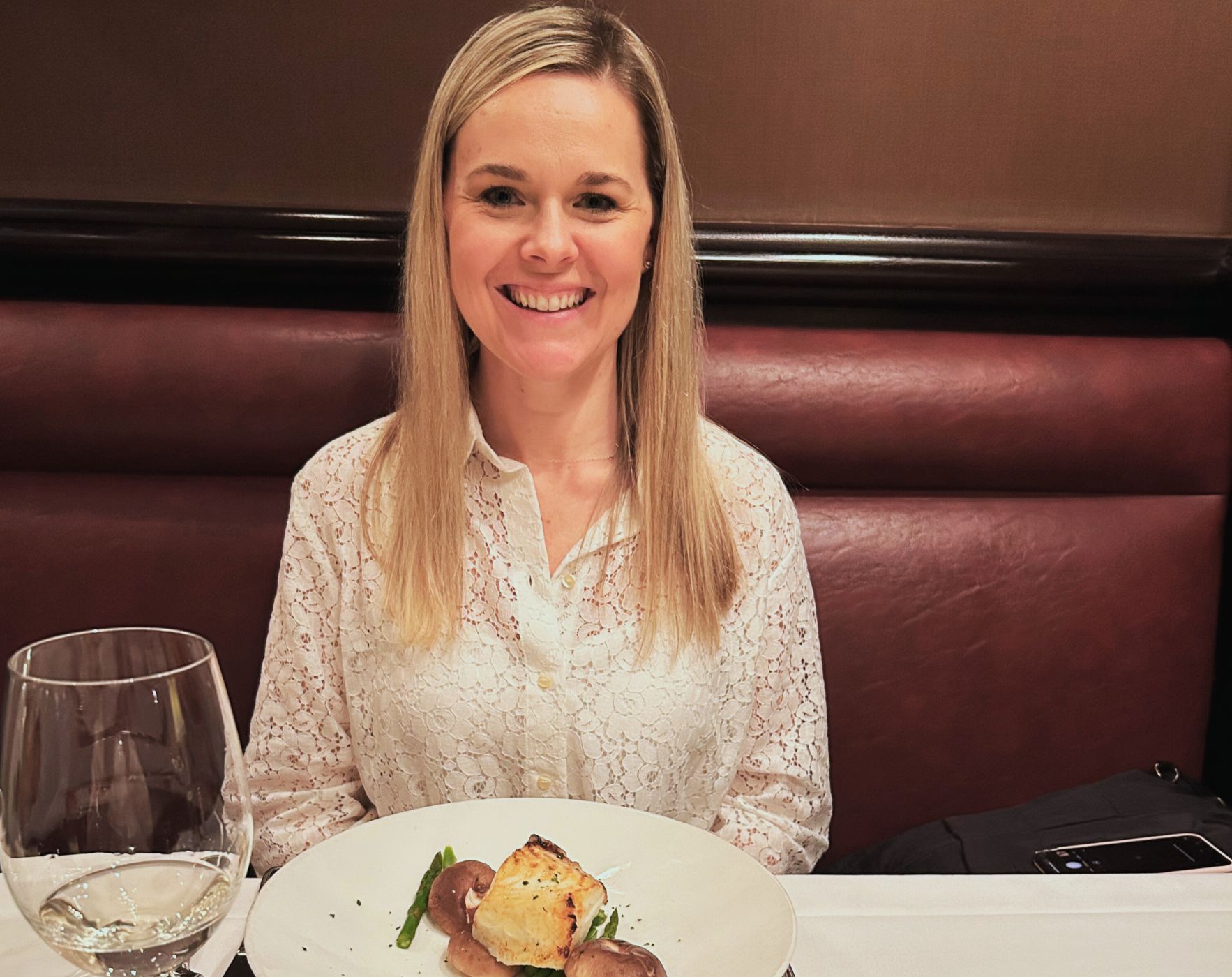 A person happily eating a compliant meal at a restaurant, representing tips for successfully eating out while following the Wahls Protocol for Multiple Sclerosis.