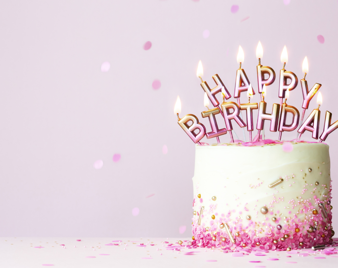 White cake with pink happy birthday candles to celebrate MS Nutritionist and Wahls Protocol Practitioner Alene Brennan