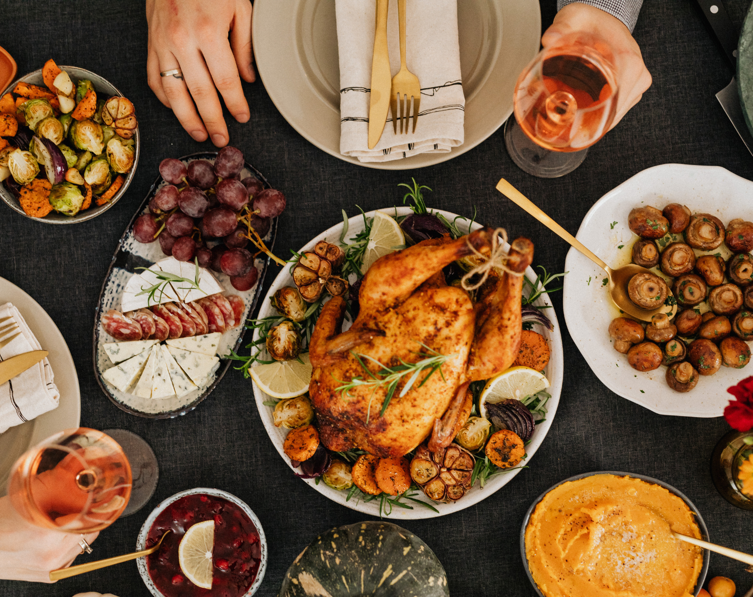 Overhead view of a Thanksgiving dinner table with roasted turkey, vegetables, and wine, representing a mindful MS-friendly holiday meal