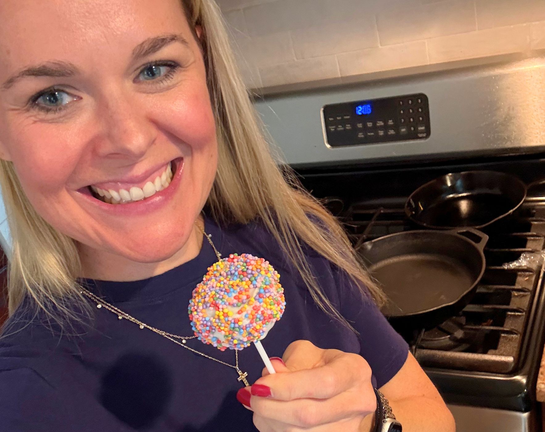 Alene Brennan, nutritionist living with MS, smiling in her kitchen with an allergy-friendly sprinkle cake pop